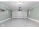 Spacious garage with white walls, concrete floor, and automatic door at 4316 Village Trace Dr, Indianapolis, IN 46254