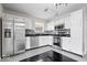 Well-equipped kitchen featuring stainless steel appliances, white cabinets, and tiled backsplash at 4316 Village Trace Dr, Indianapolis, IN 46254