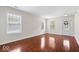 Bright and airy living room with gleaming hardwood floors, large windows, and a welcoming atmosphere at 4316 Village Trace Dr, Indianapolis, IN 46254