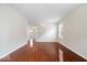 Open-concept living area showcasing hardwood floors, fresh paint, and easy access to the staircase and other living areas at 4316 Village Trace Dr, Indianapolis, IN 46254