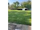 Large, green backyard with multiple storage sheds and mature trees at 4336 Bittersweet Ln, Greenwood, IN 46142