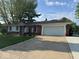 Charming brick ranch home with a two-car garage and well-manicured lawn at 4336 Bittersweet Ln, Greenwood, IN 46142