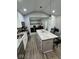 Modern kitchen with stainless steel appliances, a granite island, and sleek lighting at 4336 Bittersweet Ln, Greenwood, IN 46142