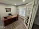 Bright office space with a large desk, natural light, and hardwood floors at 4336 Bittersweet Ln, Greenwood, IN 46142