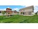 Spacious backyard features a playset, outdoor seating, and fire pit at 4763 W Tradwell Dr, New Palestine, IN 46163