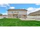 Well-manicured backyard with a patio seating area and lush green lawn at 4763 W Tradwell Dr, New Palestine, IN 46163