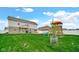 Spacious backyard with a playset and patio area, perfect for outdoor activities at 4763 W Tradwell Dr, New Palestine, IN 46163