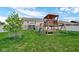 Large backyard with a wooden playset, slide, and swing set at 4763 W Tradwell Dr, New Palestine, IN 46163