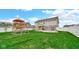 Large backyard featuring a playset, covered patio, and fire pit area for Gathering fun at 4763 W Tradwell Dr, New Palestine, IN 46163