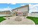 Expansive backyard patio features a stone fire pit and outdoor seating, perfect for entertaining at 4763 W Tradwell Dr, New Palestine, IN 46163