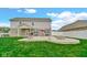 Large patio with seating, a fire pit, and room to grill complements this spacious backyard at 4763 W Tradwell Dr, New Palestine, IN 46163