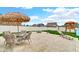 Relaxing backyard patio with a dining set and lounge chair with a play area beyond the fence at 4763 W Tradwell Dr, New Palestine, IN 46163