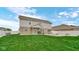 Spacious, green backyard with a patio area with an umbrella and seating arrangement at 4763 W Tradwell Dr, New Palestine, IN 46163
