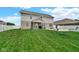 Green backyard with patio and a play set at 4763 W Tradwell Dr, New Palestine, IN 46163