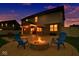 Inviting backyard with a cozy fire pit and chairs, perfect for outdoor relaxation at 4763 W Tradwell Dr, New Palestine, IN 46163