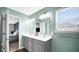 Stylish bathroom with double sinks, vanity mirror, elegant lighting, and wood-style flooring at 4763 W Tradwell Dr, New Palestine, IN 46163