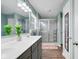 Modern bathroom with double sink vanity, enclosed shower, and bright lighting at 4763 W Tradwell Dr, New Palestine, IN 46163