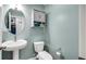 Charming half-bathroom features modern fixtures, a round mirror, and stylish wall cabinet at 4763 W Tradwell Dr, New Palestine, IN 46163
