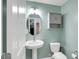 Charming bathroom featuring a pedestal sink, updated lighting, and a wall-mounted cabinet at 4763 W Tradwell Dr, New Palestine, IN 46163