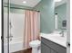 Well-lit bathroom with a shower-tub combination, a gray vanity, and a decorative pink shower curtain at 4763 W Tradwell Dr, New Palestine, IN 46163