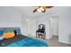 Bedroom featuring a ceiling fan, carpeted floors, a dresser and large windows offering natural light at 4763 W Tradwell Dr, New Palestine, IN 46163