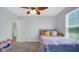 Bedroom showcasing a decorative ceiling fan and large window providing natural light at 4763 W Tradwell Dr, New Palestine, IN 46163