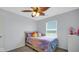 Bedroom showcasing a decorative ceiling fan and large window providing natural light at 4763 W Tradwell Dr, New Palestine, IN 46163