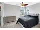 Bedroom features neutral walls, carpet floors, and a decorative ceiling fan with an adjacent vanity area at 4763 W Tradwell Dr, New Palestine, IN 46163
