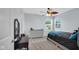 Neutral bedroom featuring a ceiling fan, carpeted floors, a dresser and large windows offering natural light at 4763 W Tradwell Dr, New Palestine, IN 46163