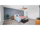 Bright bedroom with blue accent wall, plush bedding, and a view into an en-suite bathroom at 4763 W Tradwell Dr, New Palestine, IN 46163