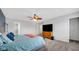 Cozy bedroom showcasing a large bed, wooden dresser, and an adjoining bathroom at 4763 W Tradwell Dr, New Palestine, IN 46163