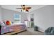 bedroom showcasing a decorative ceiling fan and an adjoining walk-in closet at 4763 W Tradwell Dr, New Palestine, IN 46163
