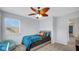 Bedroom featuring a ceiling fan, carpeted floors, a dresser and large windows offering natural light at 4763 W Tradwell Dr, New Palestine, IN 46163