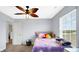 Bright bedroom with a large window, fan, and organized closet at 4763 W Tradwell Dr, New Palestine, IN 46163