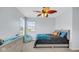 Bedroom featuring a ceiling fan, carpeted floors, a dresser and large windows offering natural light at 4763 W Tradwell Dr, New Palestine, IN 46163