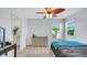 Bedroom featuring a ceiling fan, carpeted floors, a dresser and large windows offering natural light at 4763 W Tradwell Dr, New Palestine, IN 46163