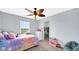 Bedroom with large window, ceiling fan and an organized walk-in closet at 4763 W Tradwell Dr, New Palestine, IN 46163
