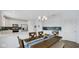 Dining area adjacent to kitchen with table, chairs, and modern lighting fixture at 4763 W Tradwell Dr, New Palestine, IN 46163
