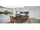 Open-concept dining area with white cabinets and sight lines into the modern kitchen at 4763 W Tradwell Dr, New Palestine, IN 46163