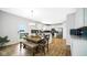 Open-concept dining area with white cabinets and sight lines into the modern kitchen at 4763 W Tradwell Dr, New Palestine, IN 46163