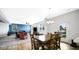 Spacious dining room with a wooden table, chairs, and chandelier next to the sliding glass door at 4763 W Tradwell Dr, New Palestine, IN 46163