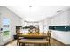 Open-concept dining area with white cabinets and sight lines into the modern kitchen at 4763 W Tradwell Dr, New Palestine, IN 46163