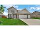 Charming two-story home with a two-car garage, landscaped lawn, brick and siding facade at 4763 W Tradwell Dr, New Palestine, IN 46163