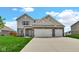 Charming two-story home with a three car garage and well-manicured lawn at 4763 W Tradwell Dr, New Palestine, IN 46163