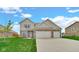 Charming two-story home with a well-manicured lawn and a two car garage at 4763 W Tradwell Dr, New Palestine, IN 46163