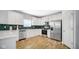 Modern kitchen featuring stainless steel appliances, white cabinets, and a beautiful backsplash at 4763 W Tradwell Dr, New Palestine, IN 46163