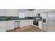 Modern kitchen featuring stainless steel appliances, white cabinets, and backsplash at 4763 W Tradwell Dr, New Palestine, IN 46163