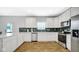 Modern kitchen featuring stainless steel appliances, white cabinets, and a beautiful backsplash at 4763 W Tradwell Dr, New Palestine, IN 46163