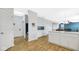 Open-concept area with white cabinets, modern appliances, and sight lines into the dining and living room at 4763 W Tradwell Dr, New Palestine, IN 46163
