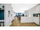 Open-concept area with white cabinets, modern appliances, and sight lines into the dining and living room at 4763 W Tradwell Dr, New Palestine, IN 46163
